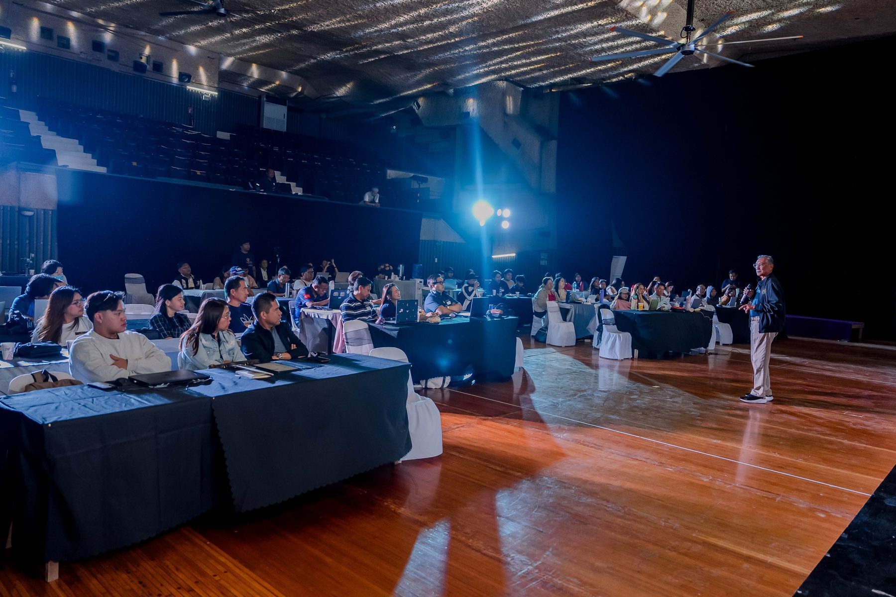 A full auditorium of business owners and professionals working through the AI Academy sessions